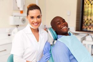 man receiving teeth cleaning services