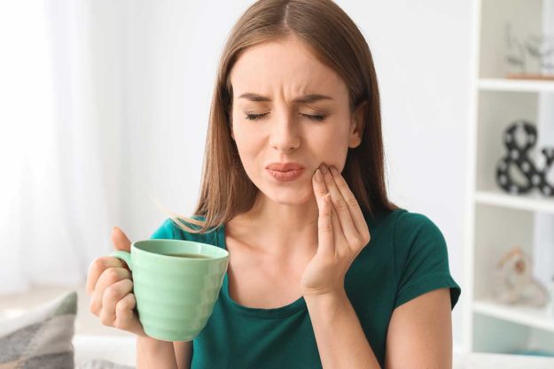 5-Signs-You-Need-to-Make-a-Dental-Appointment woman realizes she needs a dentistry appt
