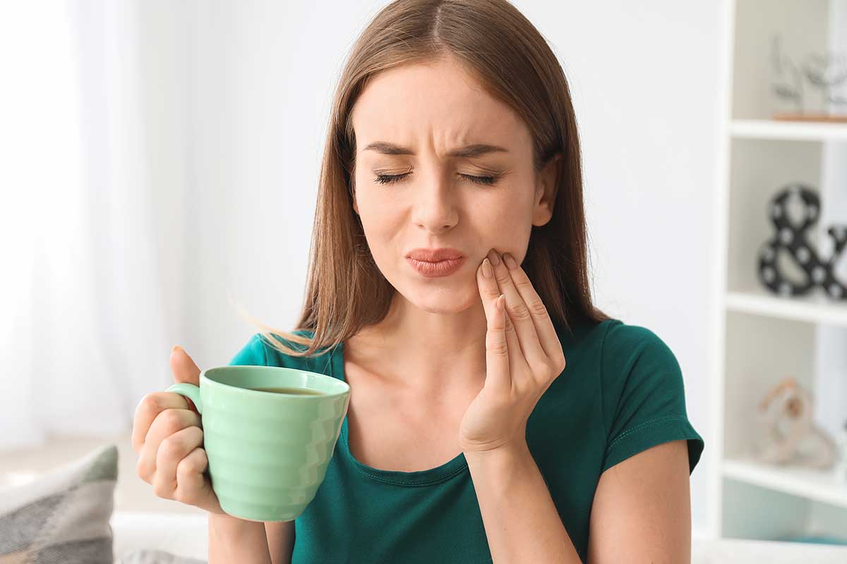 5-Signs-You-Need-to-Make-a-Dental-Appointment woman realizes she needs a dentistry appt