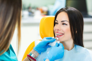 woman getting services for dental crowns and bridges