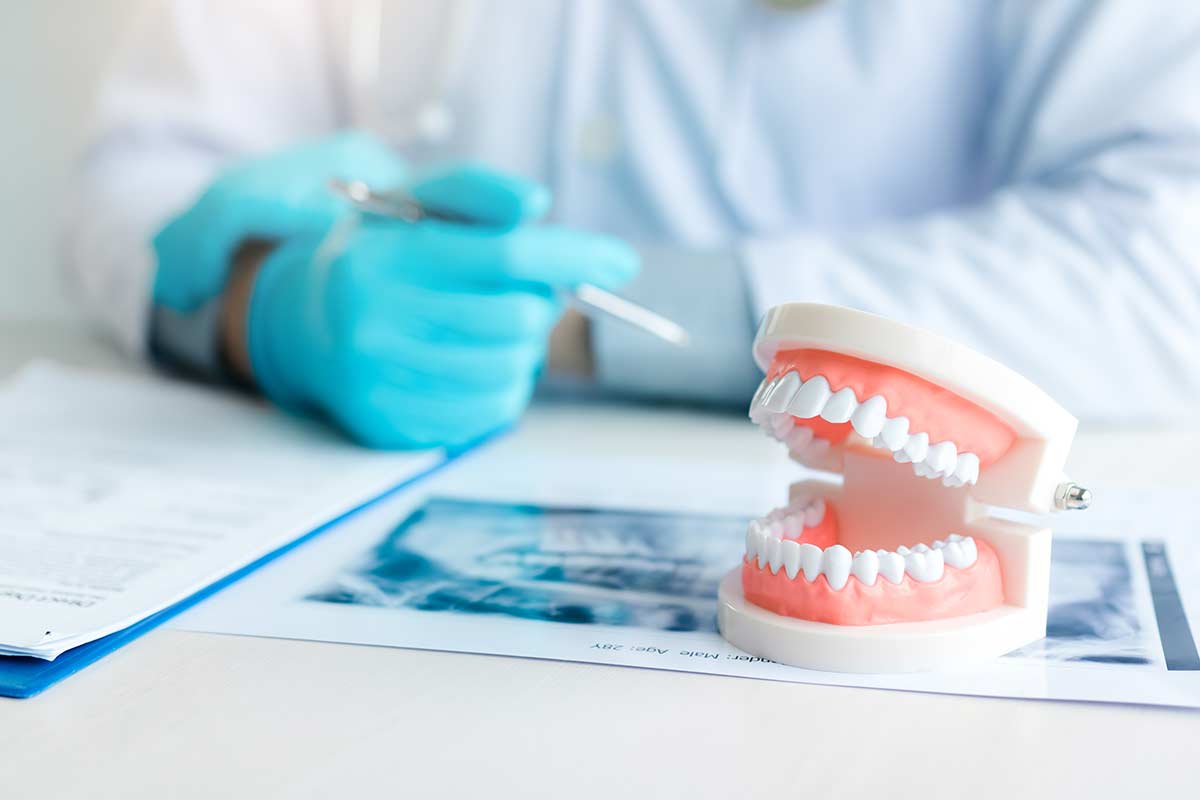 implants-or-dentures-which-is-better dentist discussing dentures and dental implants